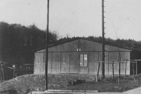 View of barrack No. 25, where the labor statistics were located. In front: wooden scaffolding for hanging fire hoses.