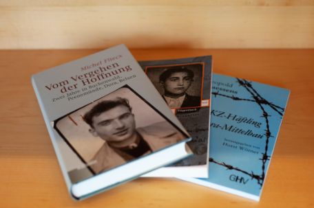 Three overlapping memoirs about the Mittelbau-Dora concentration camp from right to left.